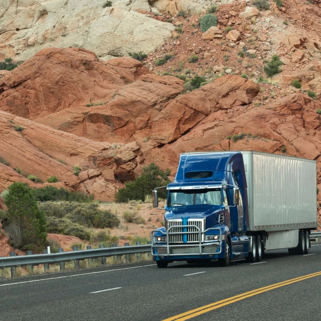 semi truck driving down the road
