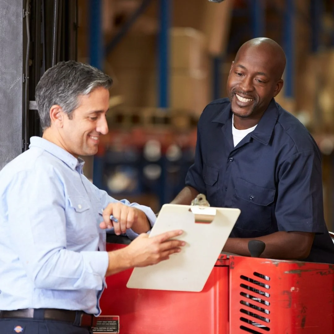 Image of workers looking at a clipboard