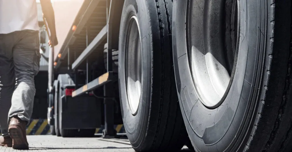 Close up image of a semi truck tire on a truck approaching a weighbridge.