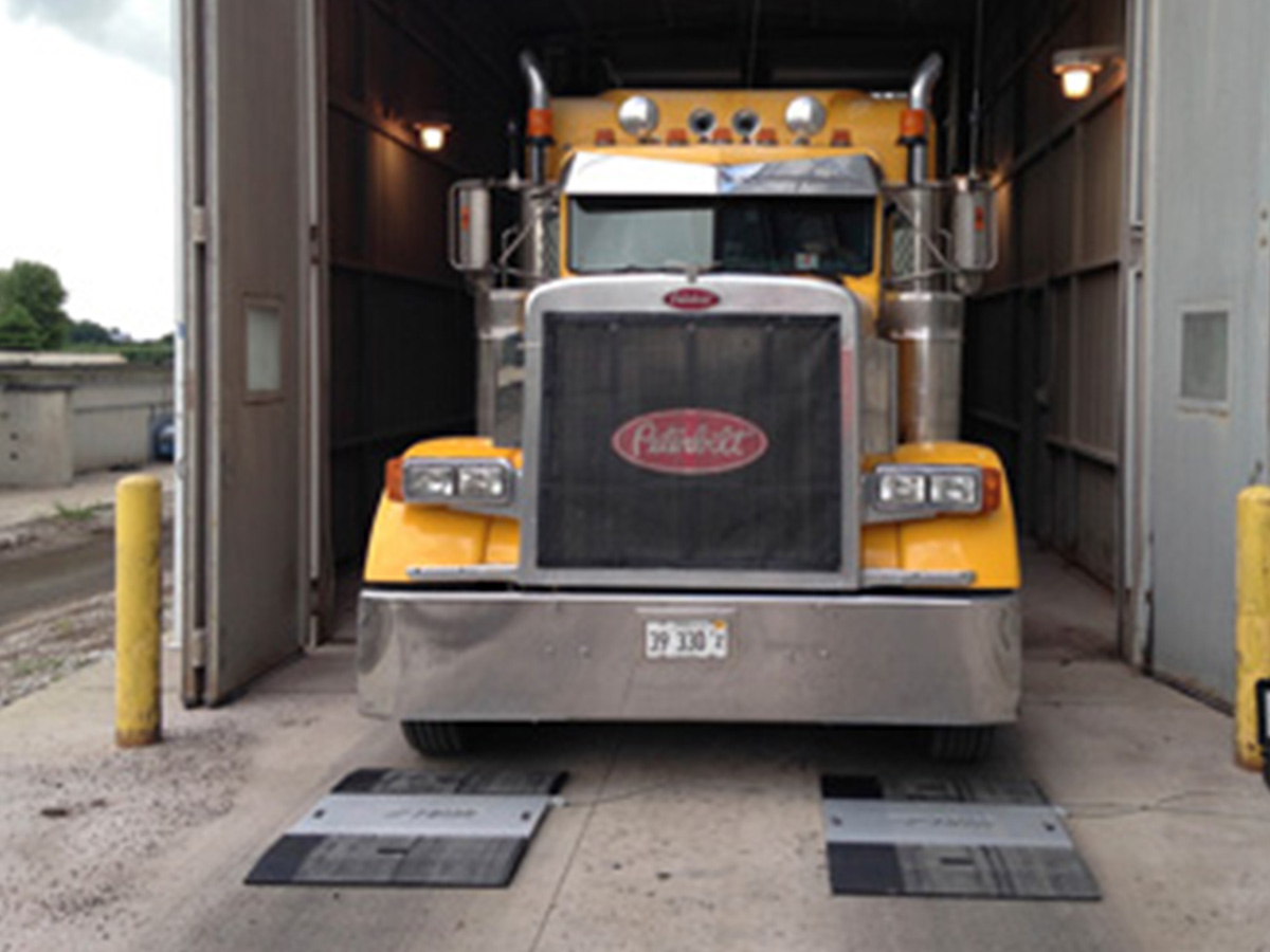 photo of truck driving over wheel weighers